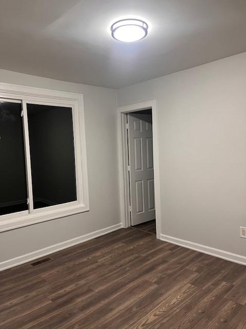 empty room featuring dark hardwood / wood-style floors