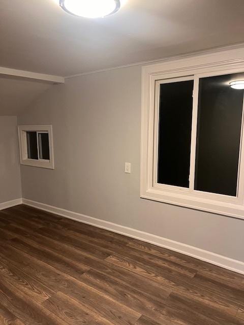 empty room with lofted ceiling and dark hardwood / wood-style floors