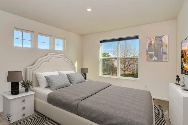 carpeted bedroom featuring multiple windows