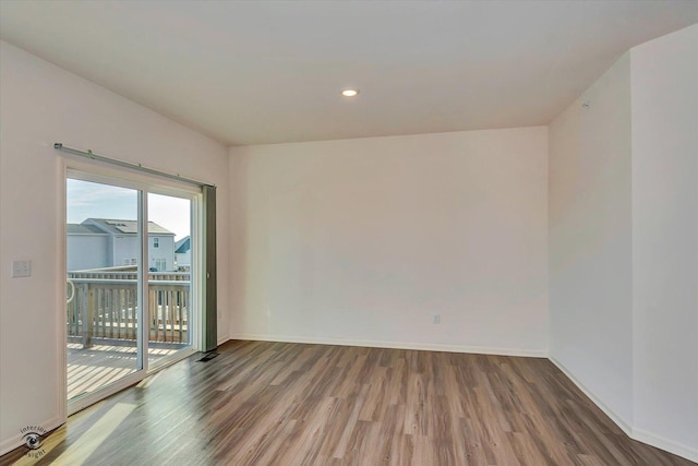 unfurnished room featuring dark hardwood / wood-style flooring