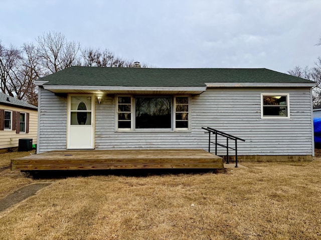 view of front of property with a front yard and cooling unit