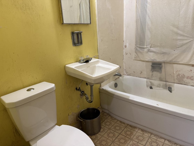 bathroom featuring a tub to relax in and toilet