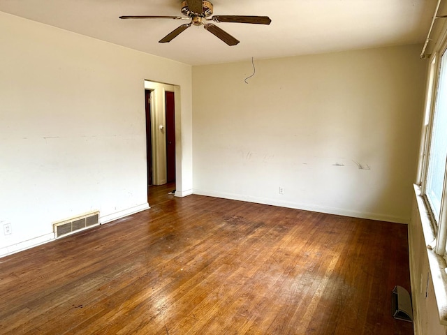 unfurnished room featuring ceiling fan and dark hardwood / wood-style flooring