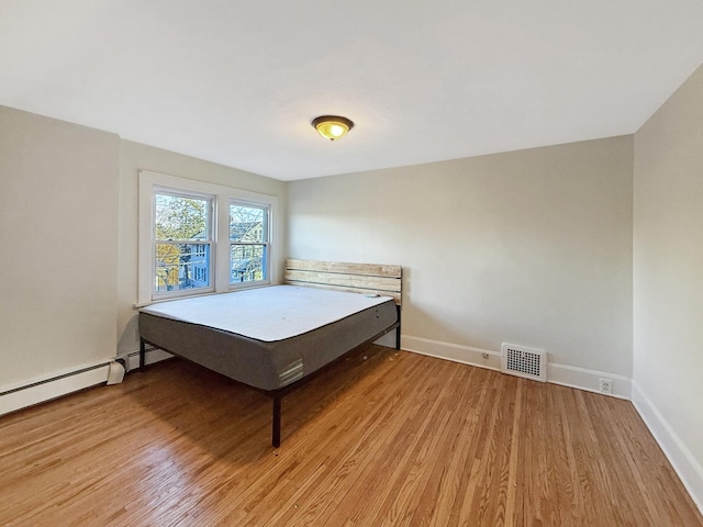 bedroom with hardwood / wood-style flooring