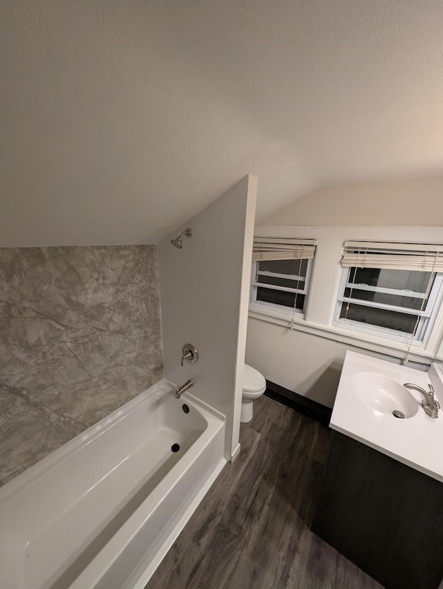 full bathroom with toilet, vaulted ceiling, a textured ceiling, vanity, and hardwood / wood-style floors