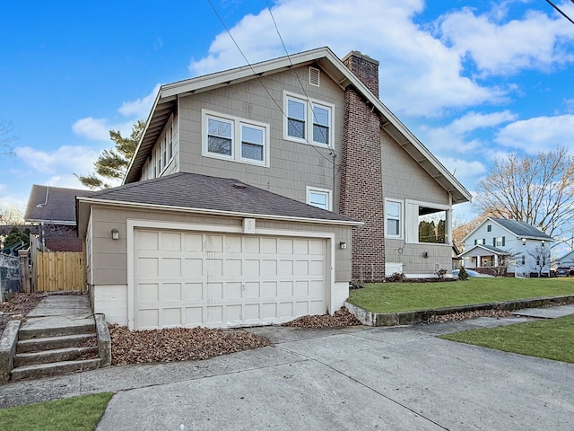 view of side of home with a garage and a lawn