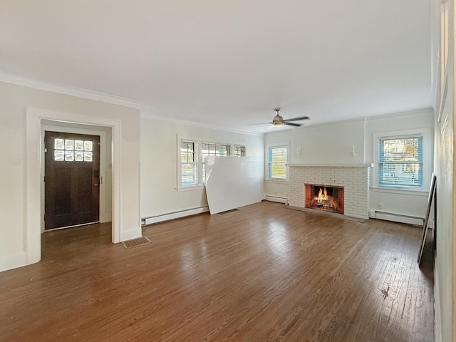 unfurnished living room with dark hardwood / wood-style flooring, a brick fireplace, crown molding, and baseboard heating