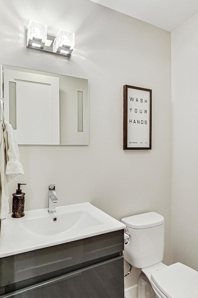 bathroom featuring vanity and toilet