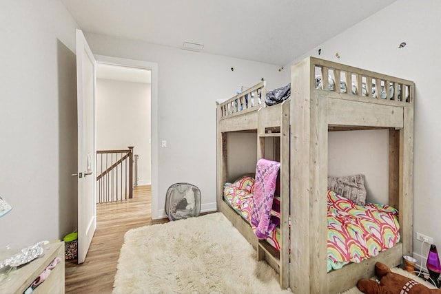 bedroom with wood finished floors and baseboards