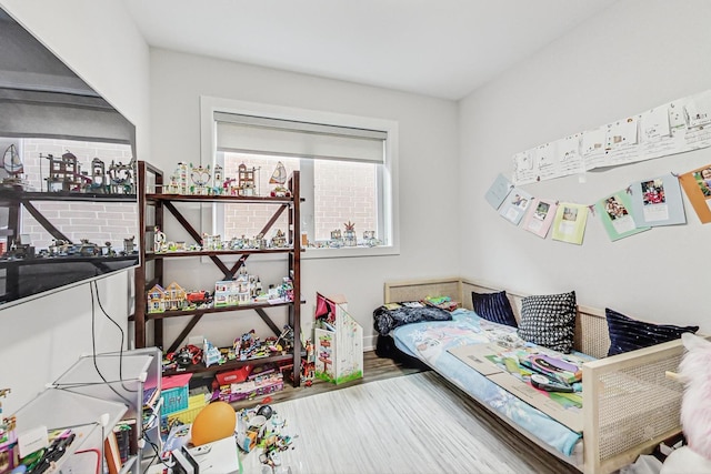 bedroom featuring baseboards and wood finished floors