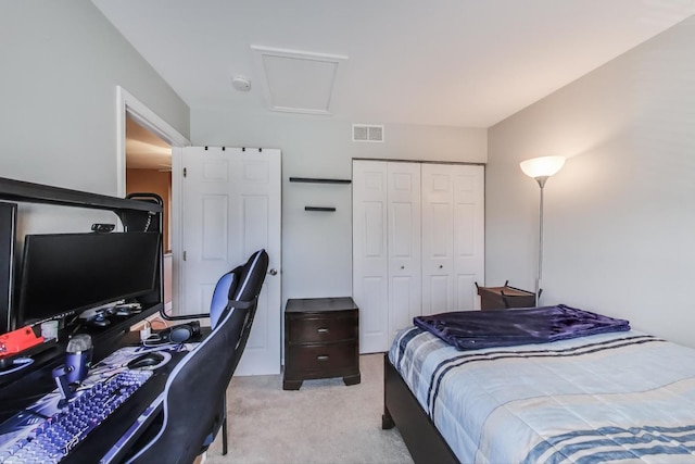 bedroom with light colored carpet, a closet, and visible vents