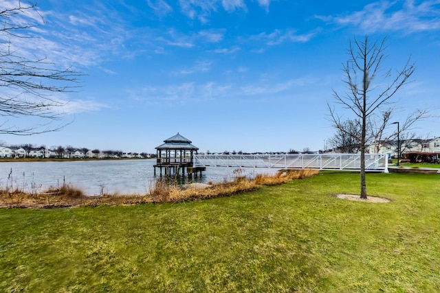 view of dock with a water view and a yard