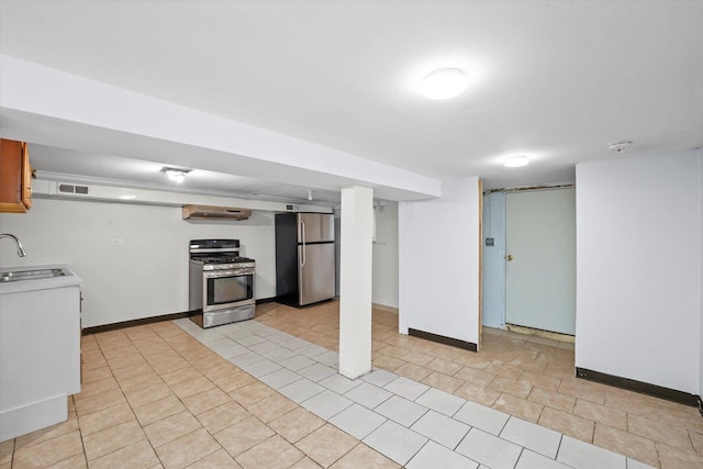 kitchen with stainless steel appliances, light tile patterned flooring, and sink