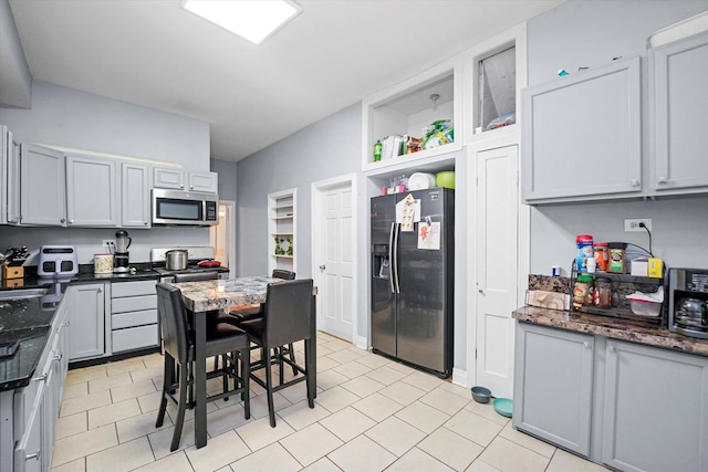 kitchen featuring appliances with stainless steel finishes, sink, and light tile patterned floors