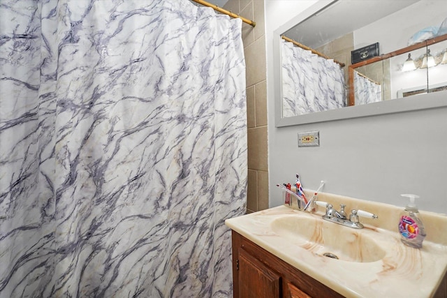 bathroom featuring vanity and curtained shower