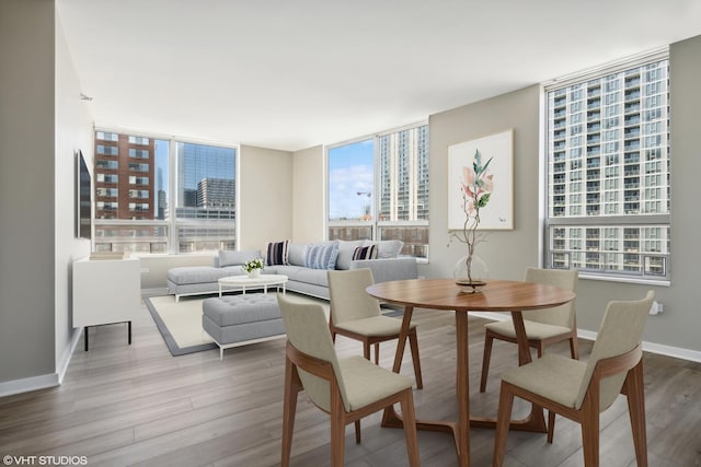 dining space featuring a healthy amount of sunlight and hardwood / wood-style floors