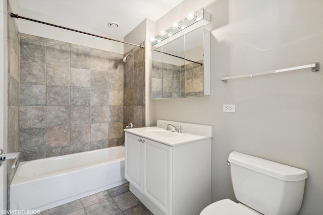 full bathroom with vanity, tiled shower / bath, tile patterned floors, and toilet