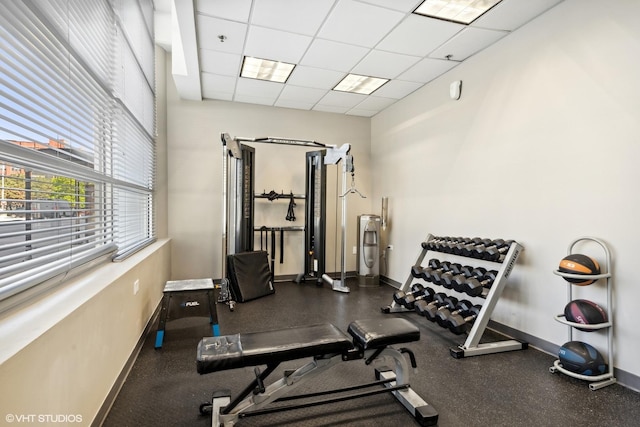 exercise room featuring a paneled ceiling