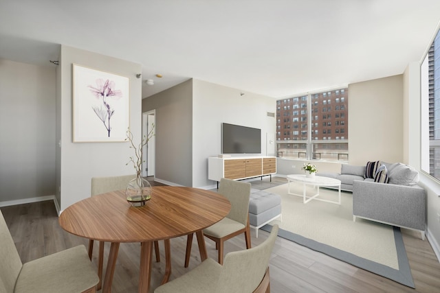 dining space with light hardwood / wood-style flooring