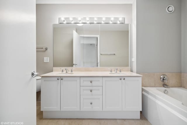 bathroom with vanity and a bathing tub