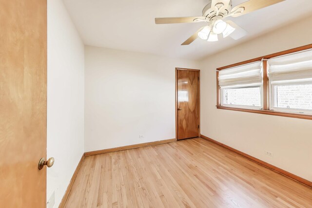 empty room with light wood-style floors, ceiling fan, and baseboards