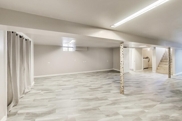 basement with stairs and baseboards