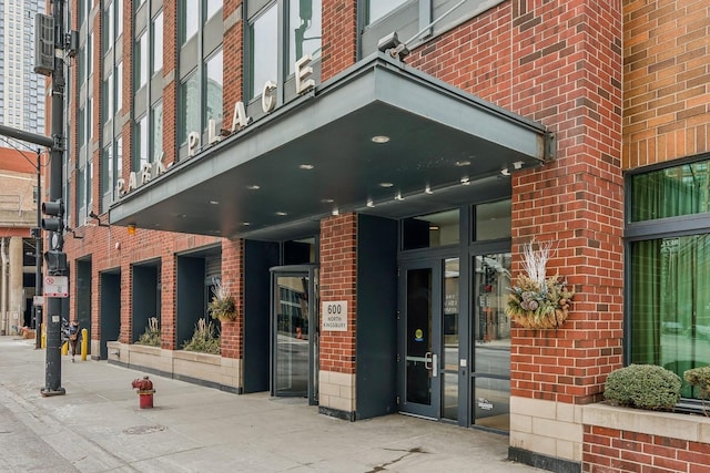 property entrance featuring brick siding