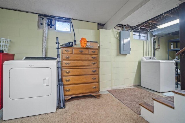 laundry room with washing machine and clothes dryer, electric panel, and a wealth of natural light