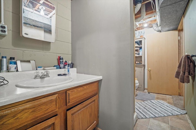 bathroom featuring vanity, tile patterned floors, and toilet