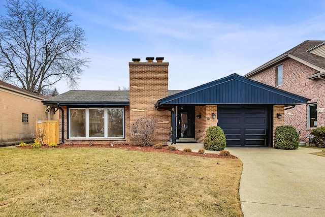 view of front of property with a garage and a front lawn