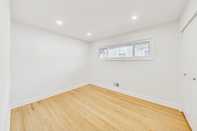 unfurnished room with light wood-type flooring