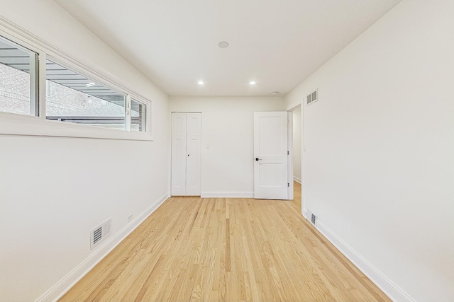 unfurnished room with light hardwood / wood-style flooring