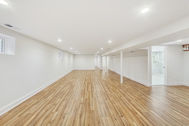 basement with light hardwood / wood-style floors