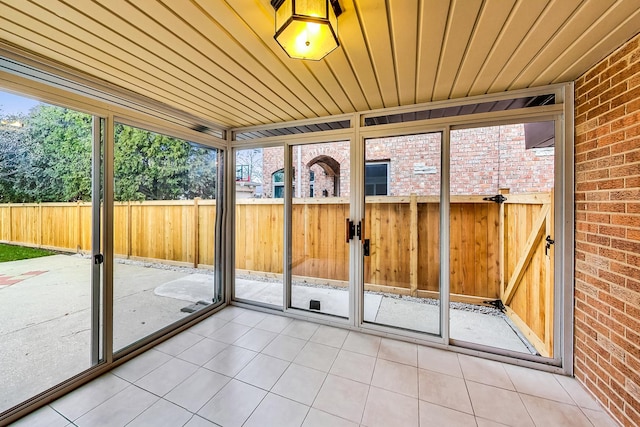 unfurnished sunroom with wooden ceiling