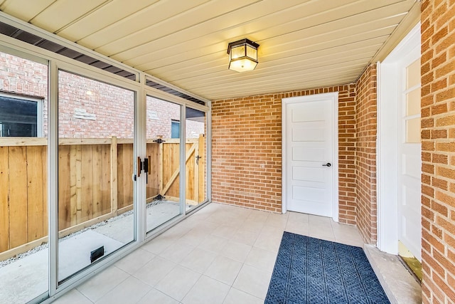 unfurnished sunroom with wooden ceiling