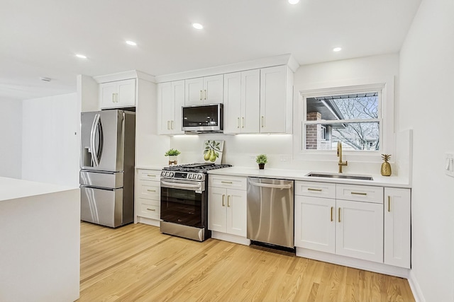 kitchen with sink, stainless steel appliances, and white cabinets