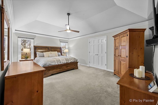 bedroom with a raised ceiling, ornamental molding, a ceiling fan, light carpet, and baseboards