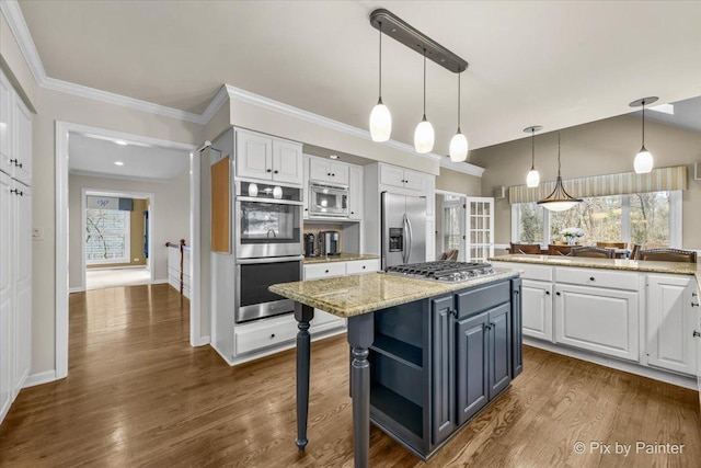 kitchen with decorative light fixtures, open shelves, white cabinets, light stone countertops, and built in appliances