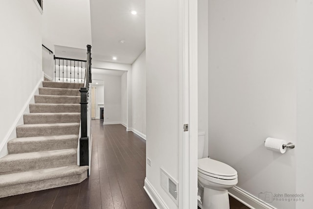 stairway with hardwood / wood-style flooring