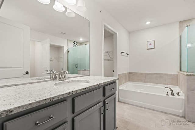 bathroom featuring vanity, tile patterned floors, and separate shower and tub