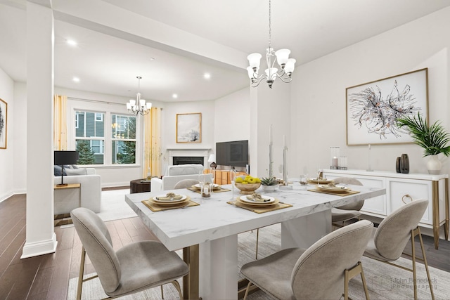 dining space featuring an inviting chandelier and dark wood-type flooring