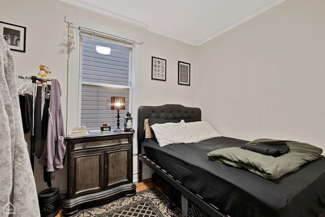 bedroom featuring hardwood / wood-style floors and crown molding