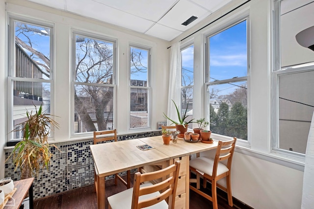 sunroom / solarium with a paneled ceiling