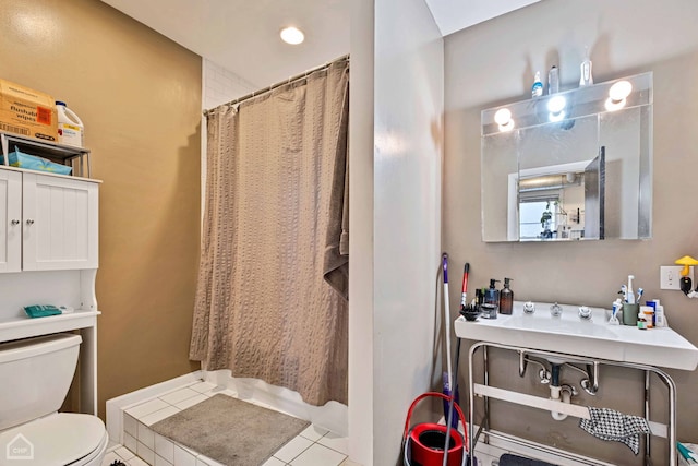 bathroom featuring tile patterned flooring, a shower with curtain, and toilet