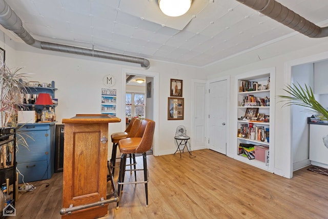 bar featuring hardwood / wood-style flooring and built in features