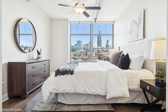 bedroom featuring ceiling fan, floor to ceiling windows, and dark hardwood / wood-style floors