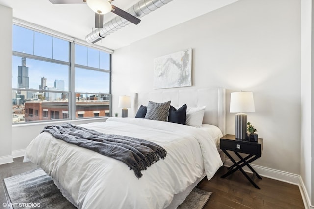 bedroom with dark hardwood / wood-style floors and ceiling fan