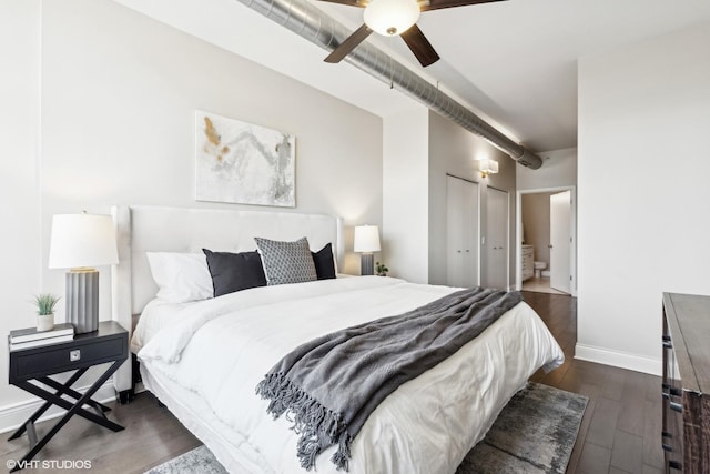 bedroom featuring ceiling fan, ensuite bathroom, and dark hardwood / wood-style floors