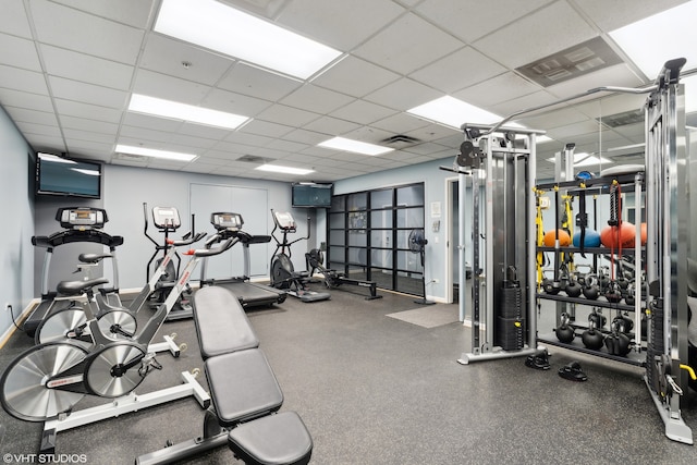 exercise room featuring a paneled ceiling