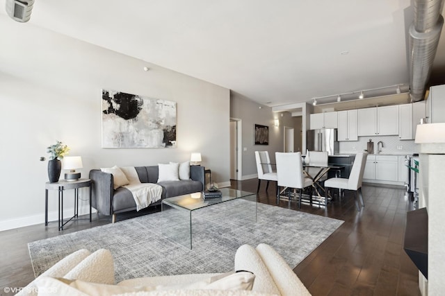 living room featuring dark wood-type flooring and sink